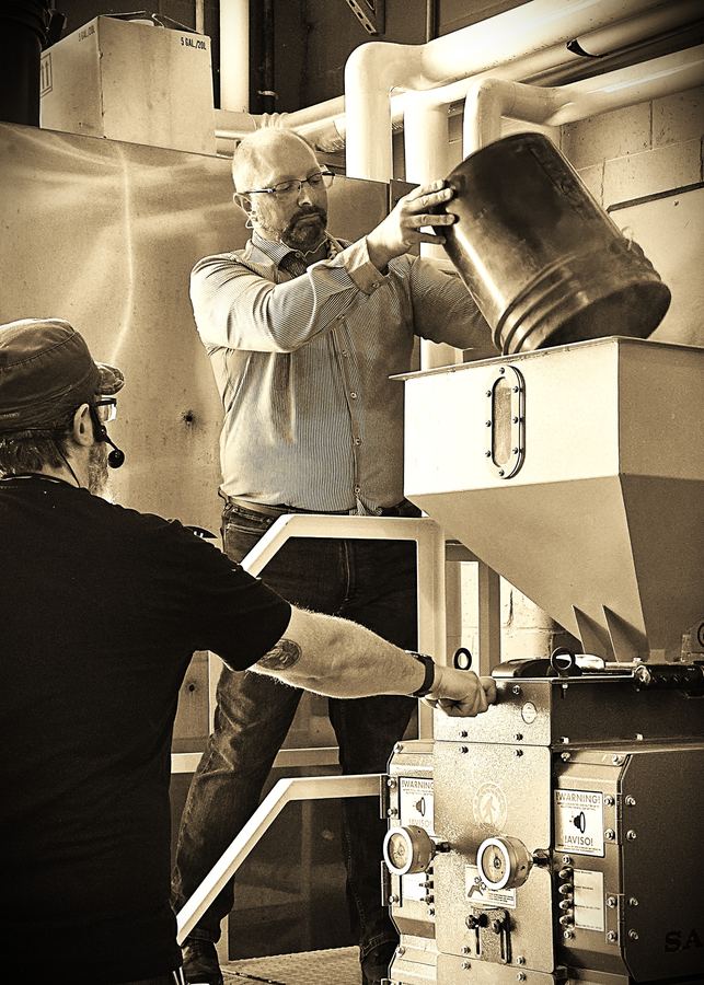 John at the grain mill on a distillery visit